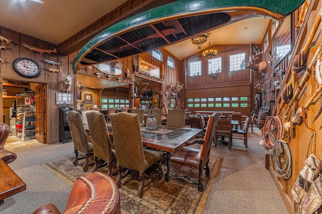 carpeted dining space featuring lofted ceiling, wood walls, and a chandelier