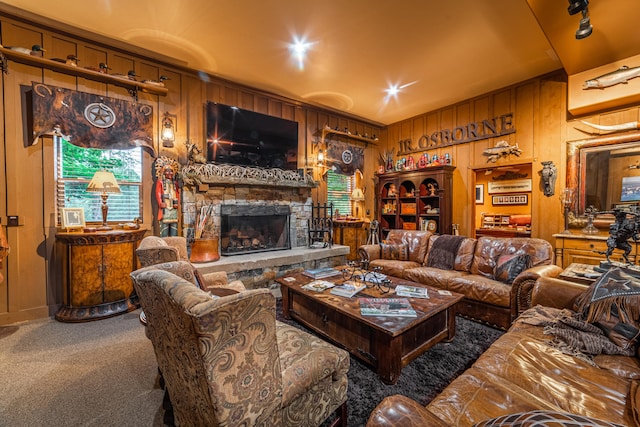 carpeted living room with wood walls and a fireplace