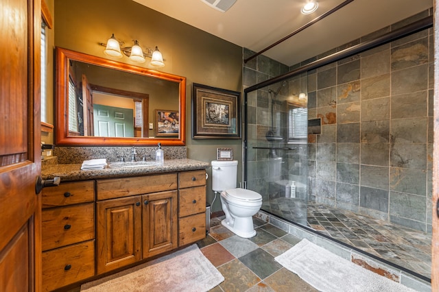 bathroom featuring walk in shower, large vanity, tile floors, and toilet