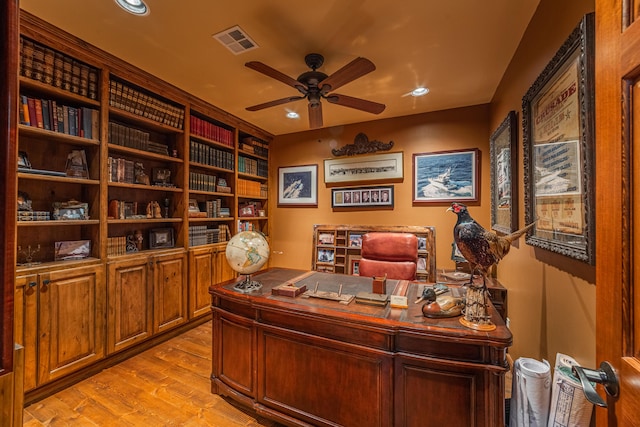 office with light hardwood / wood-style flooring and ceiling fan