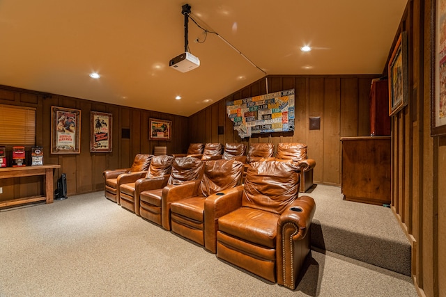 carpeted cinema featuring wood walls and lofted ceiling