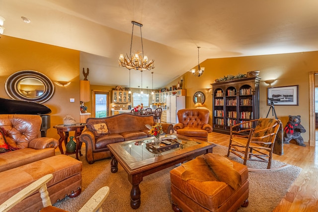 living room with vaulted ceiling, a chandelier, and light wood-type flooring