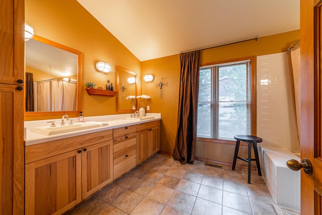 bathroom with lofted ceiling, dual bowl vanity, and tile flooring