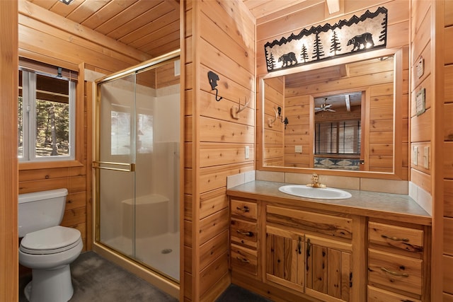 bathroom featuring wood walls, vanity with extensive cabinet space, toilet, an enclosed shower, and wooden ceiling