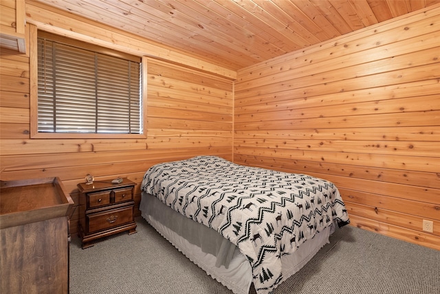 bedroom with wood ceiling, dark carpet, and wooden walls