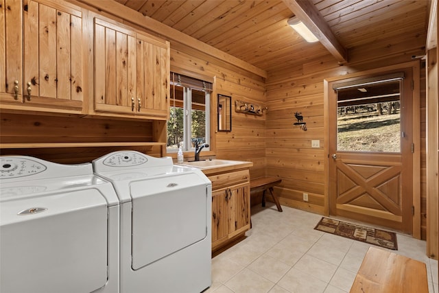 laundry room with washer and dryer, cabinets, light tile floors, wood ceiling, and wood walls