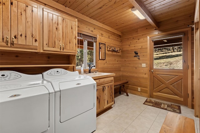 964 Elkhorn Rd, Seeley Lake, MT 59868 - laundry area featuring cabinet space, wood ceiling, washing machine and dryer, light tile patterned floors, and wood walls