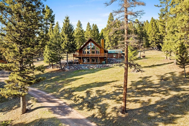 964 Elkhorn Rd, Seeley Lake, MT 59868 - view of front of property featuring a chimney, a wooden deck, and a front yard