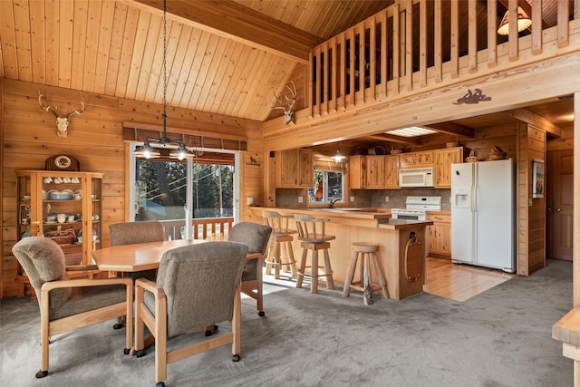 carpeted dining room featuring wood ceiling, wooden walls, beam ceiling, and high vaulted ceiling