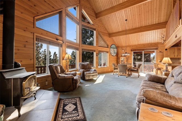 carpeted living room with high vaulted ceiling, wood ceiling, and a wood stove