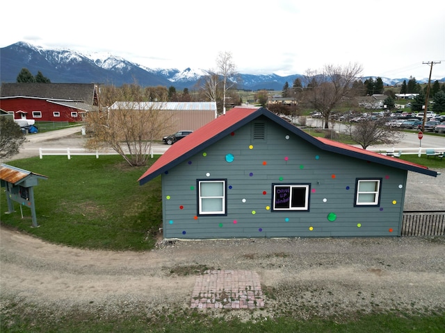 exterior space featuring a mountain view and a front yard