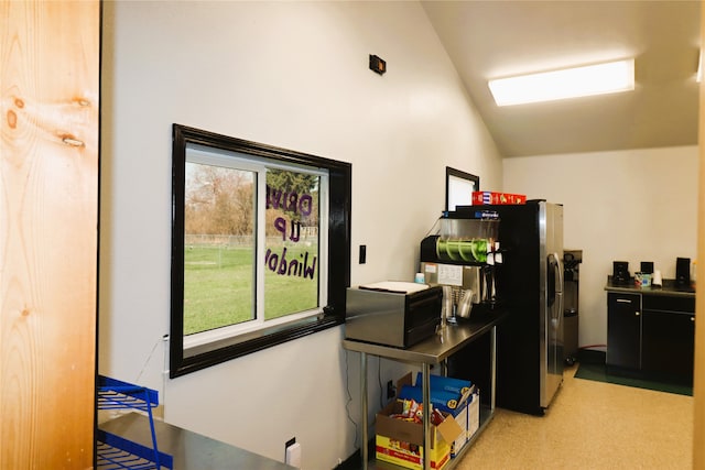 carpeted office with lofted ceiling