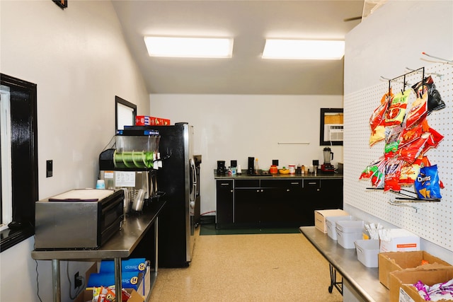 kitchen with a wall unit AC and fridge