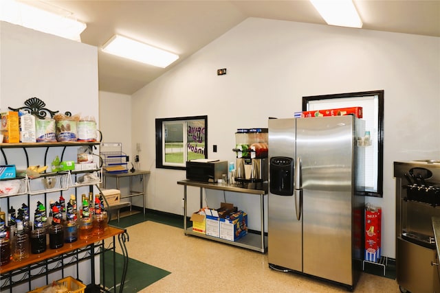 kitchen featuring light colored carpet, stainless steel refrigerator with ice dispenser, and lofted ceiling