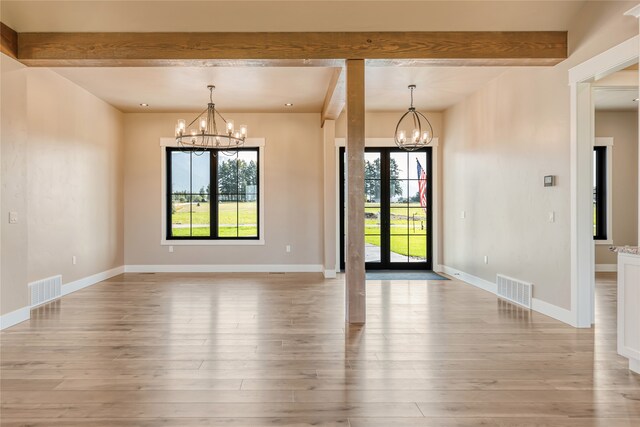 unfurnished room with a notable chandelier, beam ceiling, french doors, and light hardwood / wood-style floors