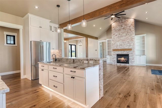 1052 Foxtail Dr, Kalispell, MT 59901 - kitchen with light wood-style floors, baseboards, open floor plan, and high quality fridge