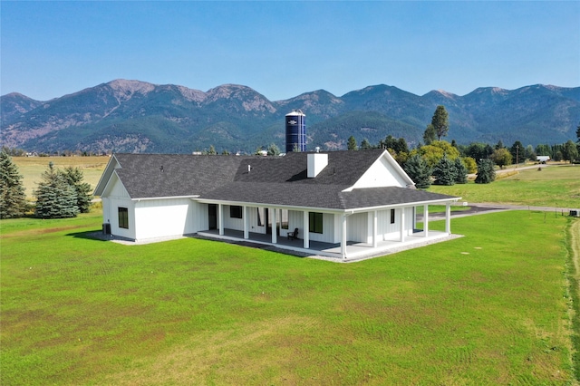 1052 Foxtail Dr, Kalispell, MT 59901 - back of property featuring a yard, covered porch, and a mountain view