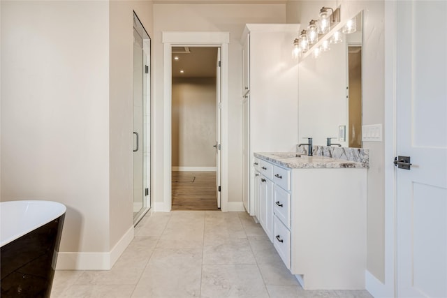 1052 Foxtail Dr, Kalispell, MT 59901 - bathroom with a soaking tub, baseboards, vanity, and a stall shower