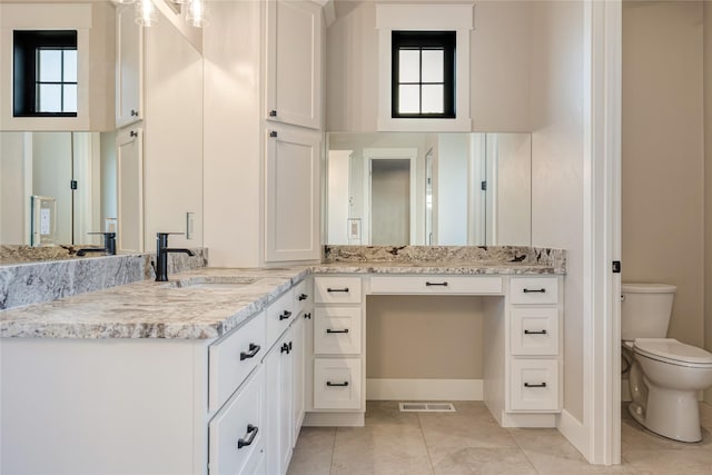 1052 Foxtail Dr, Kalispell, MT 59901 - full bath featuring tile patterned floors, toilet, visible vents, baseboards, and vanity