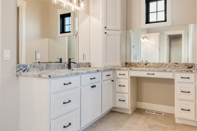 bathroom featuring tile patterned flooring and vanity