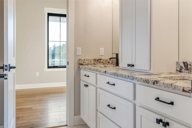 bathroom featuring vanity and hardwood / wood-style flooring