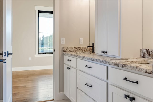 1052 Foxtail Dr, Kalispell, MT 59901 - bathroom featuring baseboards, vanity, and wood finished floors