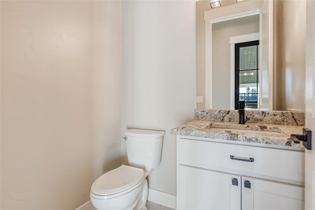 1052 Foxtail Dr, Kalispell, MT 59901 - bathroom with vanity, toilet, and baseboards