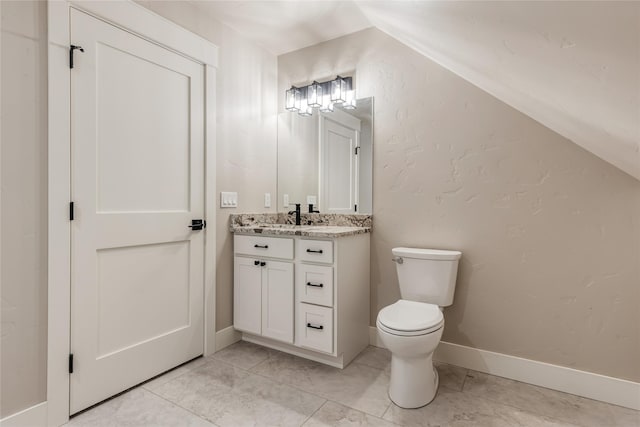 1052 Foxtail Dr, Kalispell, MT 59901 - bathroom with vaulted ceiling, vanity, and toilet