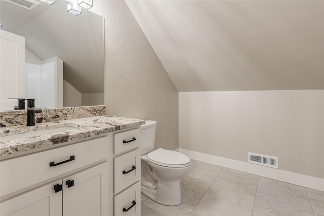 1052 Foxtail Dr, Kalispell, MT 59901 - half bathroom featuring vaulted ceiling, visible vents, vanity, and toilet
