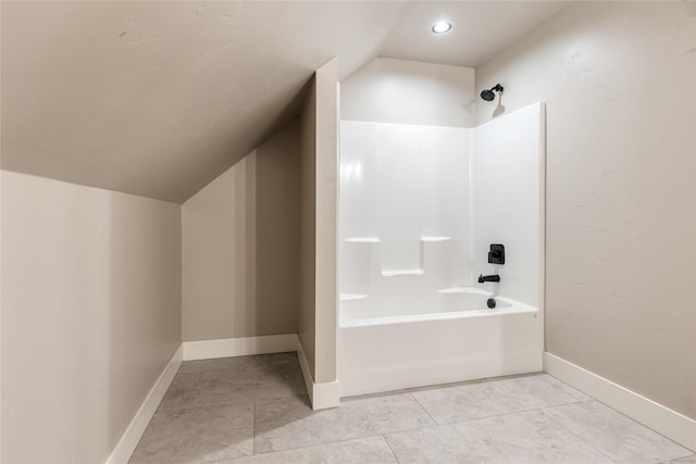 1052 Foxtail Dr, Kalispell, MT 59901 - full bathroom featuring vaulted ceiling, baseboards, and shower / washtub combination