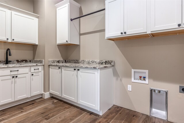 washroom featuring hookup for a washing machine, cabinets, sink, electric dryer hookup, and hardwood / wood-style flooring