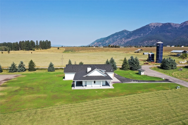 birds eye view of property featuring a mountain view and a rural view