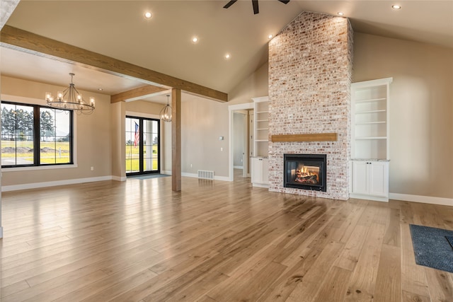 unfurnished living room featuring light hardwood / wood-style flooring, a brick fireplace, ceiling fan with notable chandelier, built in features, and high vaulted ceiling