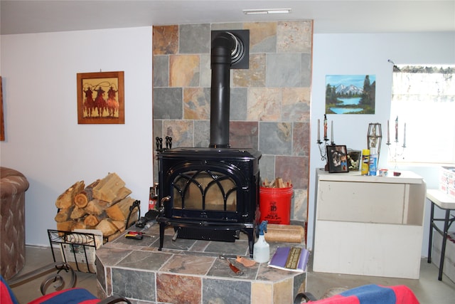 interior space with tile walls and a wood stove