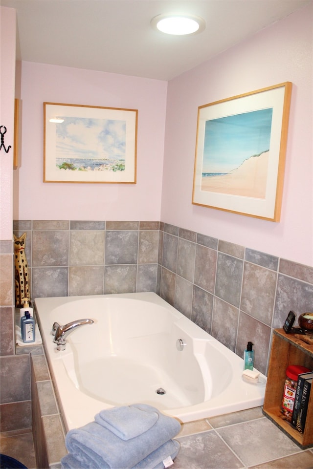 bathroom with a relaxing tiled bath