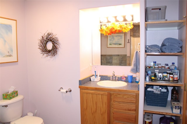 bathroom featuring toilet and vanity