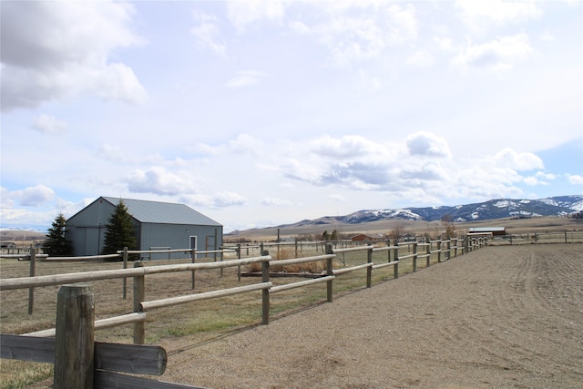 95 Furman Ln, East Helena, MT 59635 - view of yard featuring a view of countryside, an exterior structure, an outdoor structure, a mountain view, and an outdoor riding arena