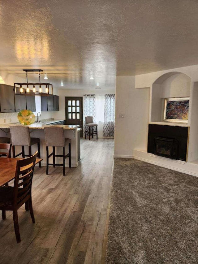 interior space with sink, dark hardwood / wood-style flooring, and a textured ceiling