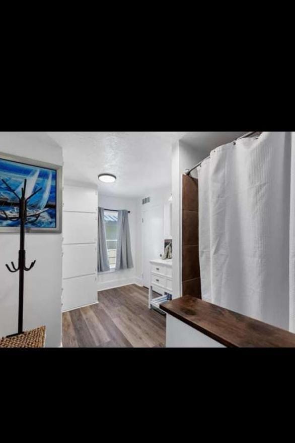 bathroom with wood-type flooring