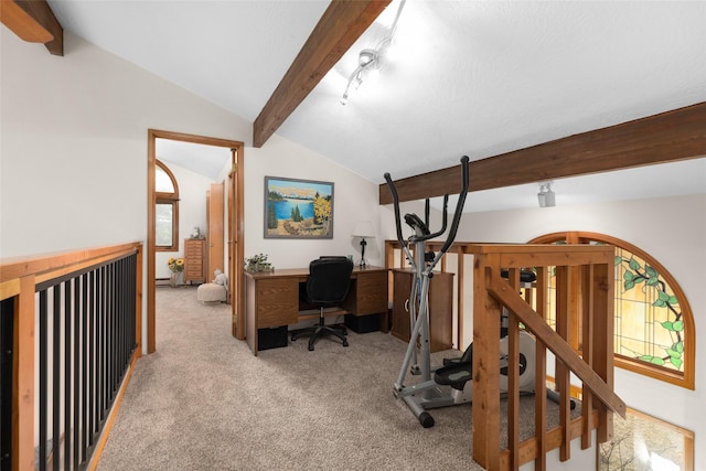 carpeted office with lofted ceiling with beams