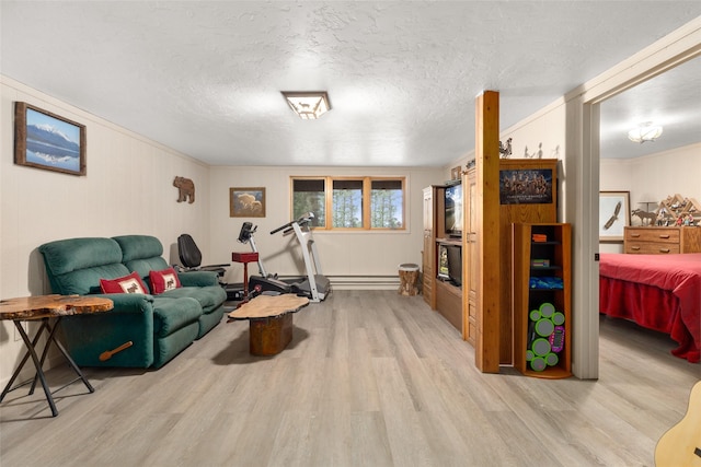 living room with crown molding, a textured ceiling, and light hardwood / wood-style flooring