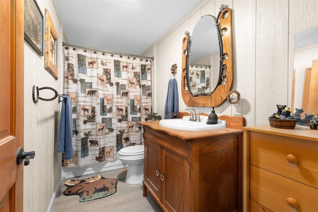 bathroom featuring vanity, hardwood / wood-style flooring, a shower with curtain, and toilet