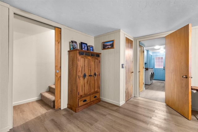 hall featuring washer / dryer and light wood-type flooring