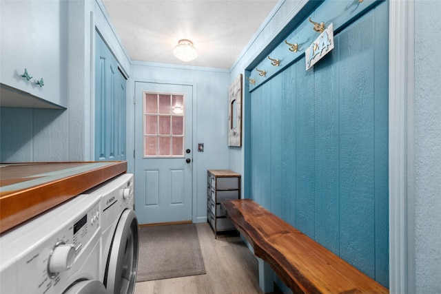 interior space with cabinets, washer and clothes dryer, and light hardwood / wood-style floors