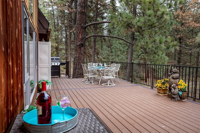 wooden terrace with a grill