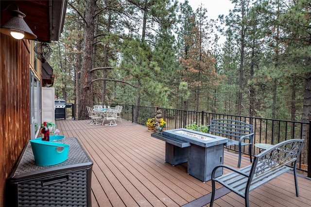 deck featuring area for grilling and an outdoor fire pit