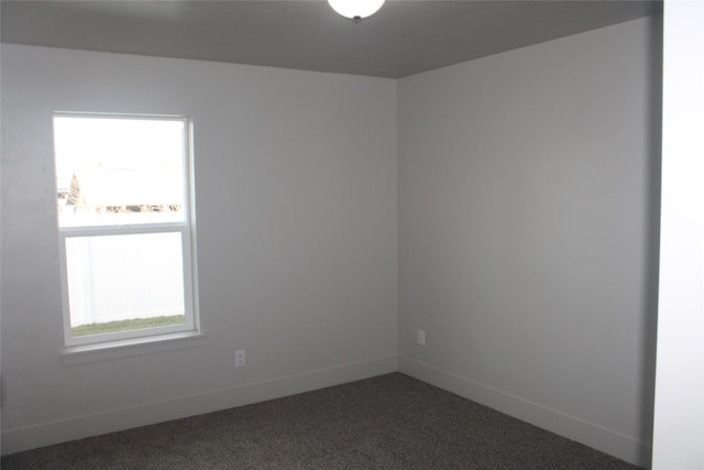 carpeted spare room featuring plenty of natural light