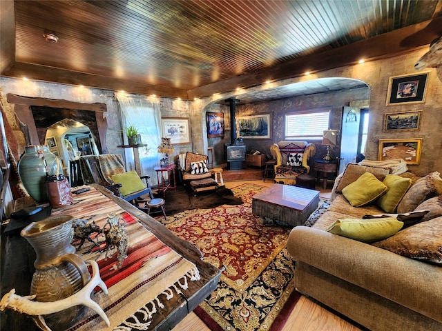 living room with wooden ceiling, light hardwood / wood-style flooring, and a wood stove