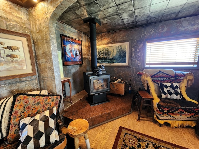 bedroom with light hardwood / wood-style flooring and a wood stove