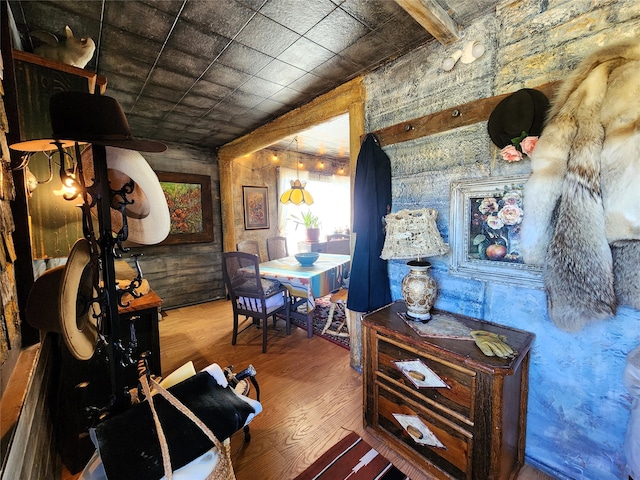 interior space featuring wooden walls and dark hardwood / wood-style floors